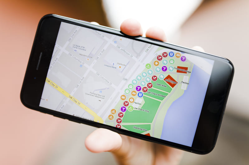 close-up-person-s-hand-holding-smartphone-with-map-gps-navigation (1) (1)