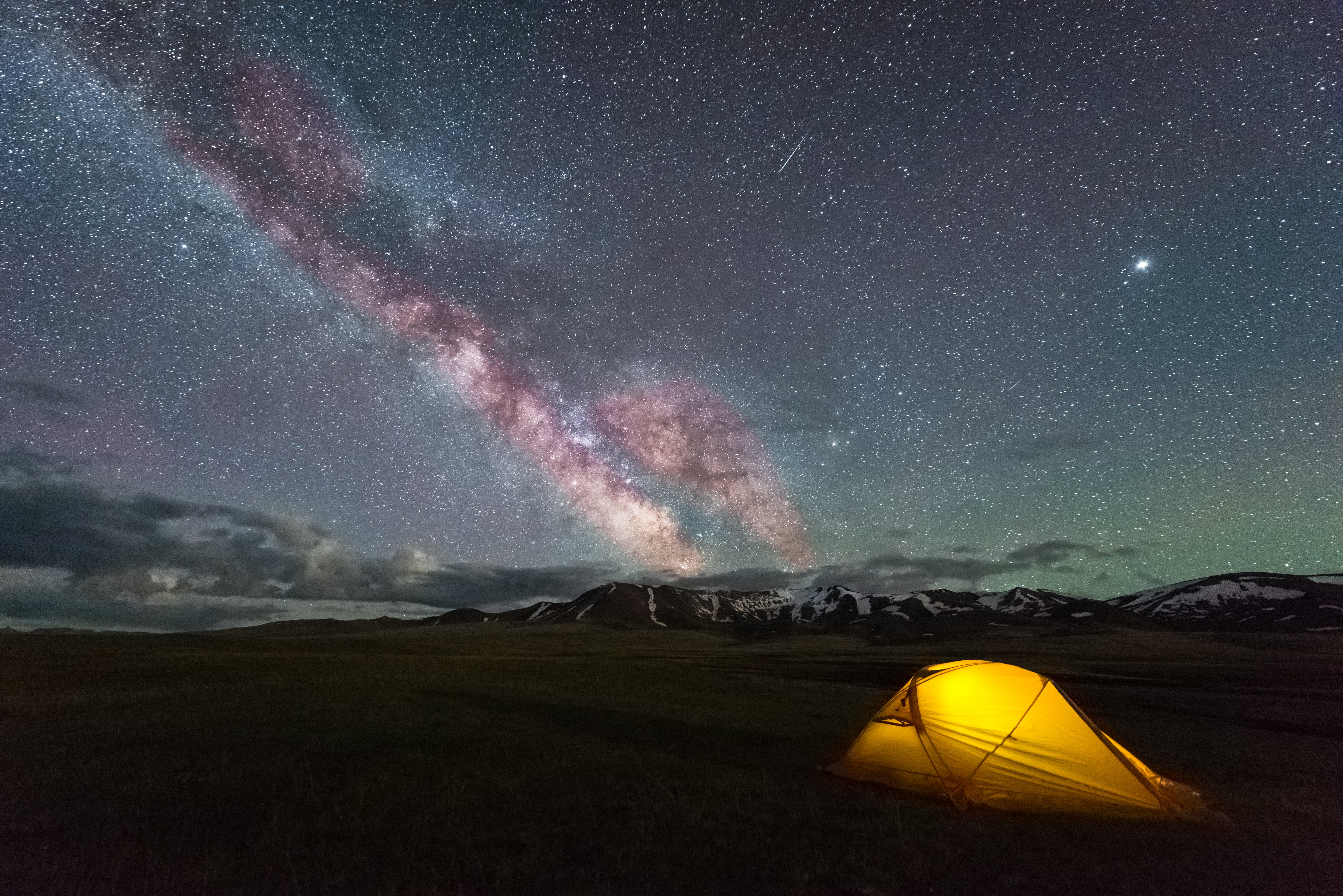 milky-way-on-starry-sky-and-yellow-tent-4VZLNFQ