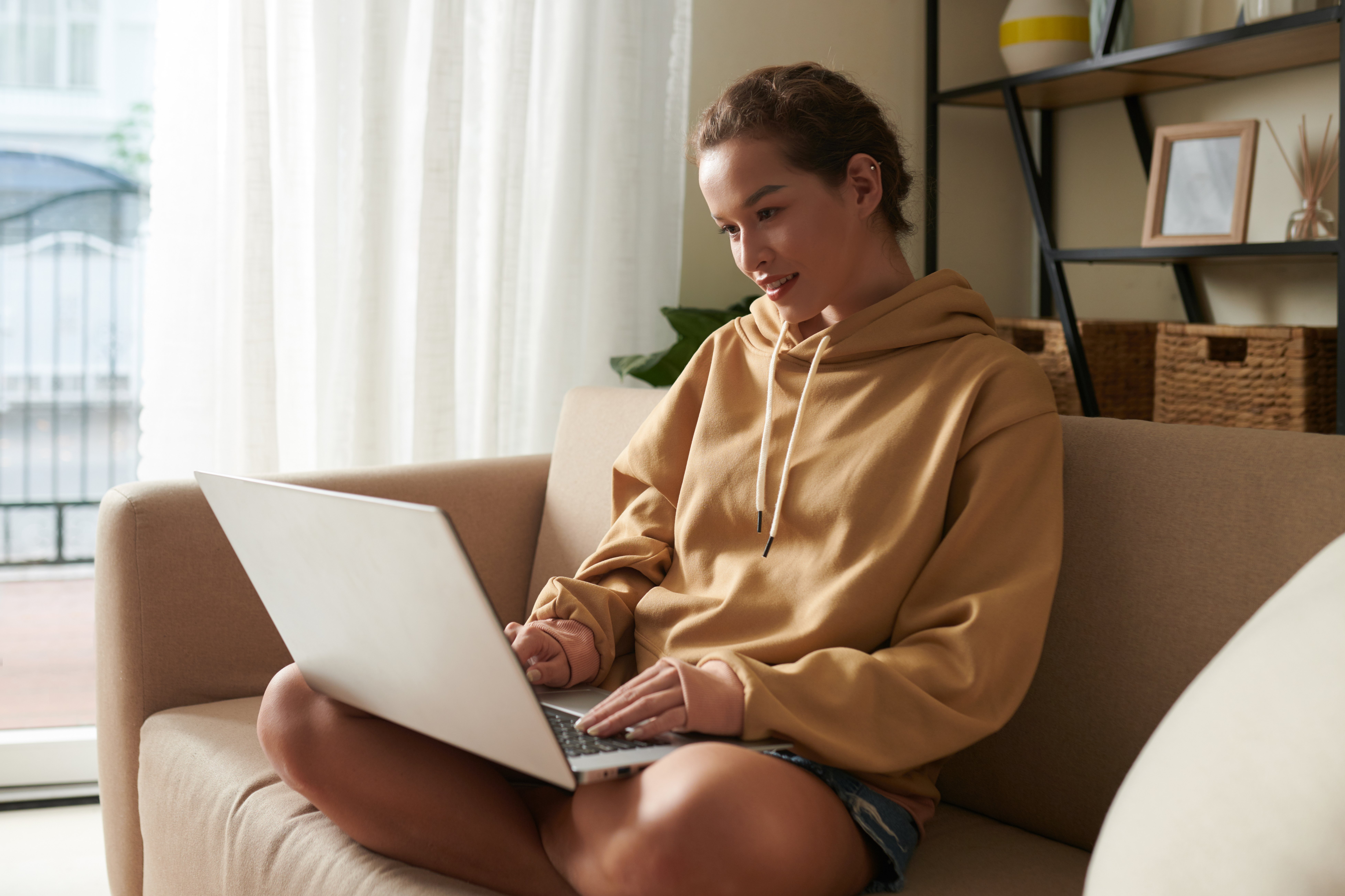 young-woman-using-laptop-at-home-2022-02-28-21-47-30-utc